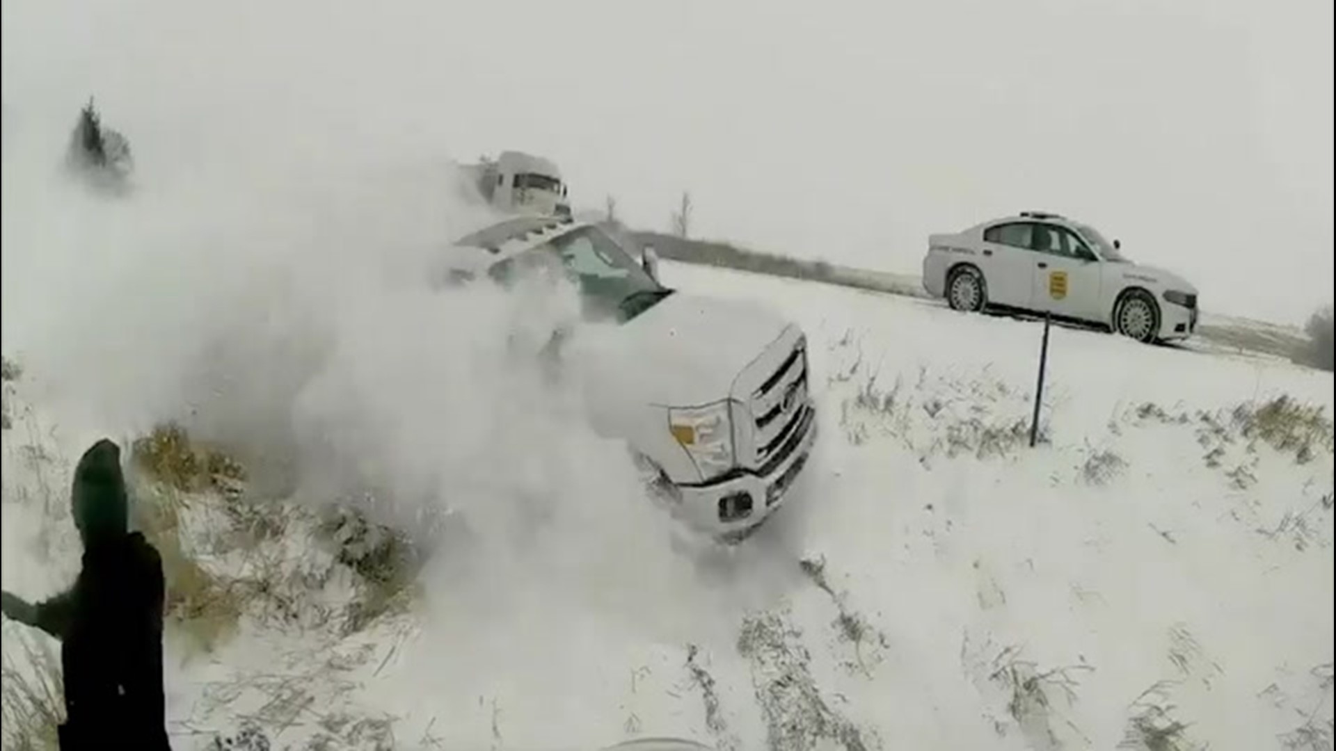 An Iowa State Trooper and a pulled over driver narrowly escaped injury when a truck lost control in snowy conditions on I-80 and slid off the road on Jan. 17.