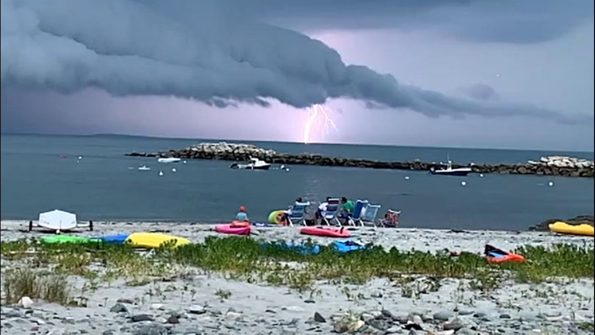 A slow-motion video shows lightning striking underneath a thunderstorm with a shelf cloud in Hull, Massachusetts, on June 28.