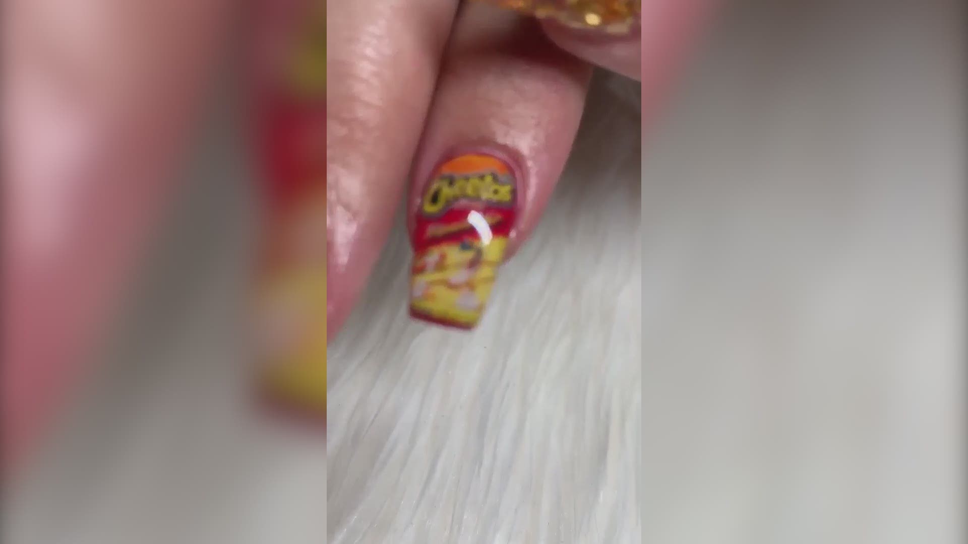 A San Antonio nail salon, Nails by Mimi, is turning up the heat with these unique Flamin' Hot Cheetos nail designs.