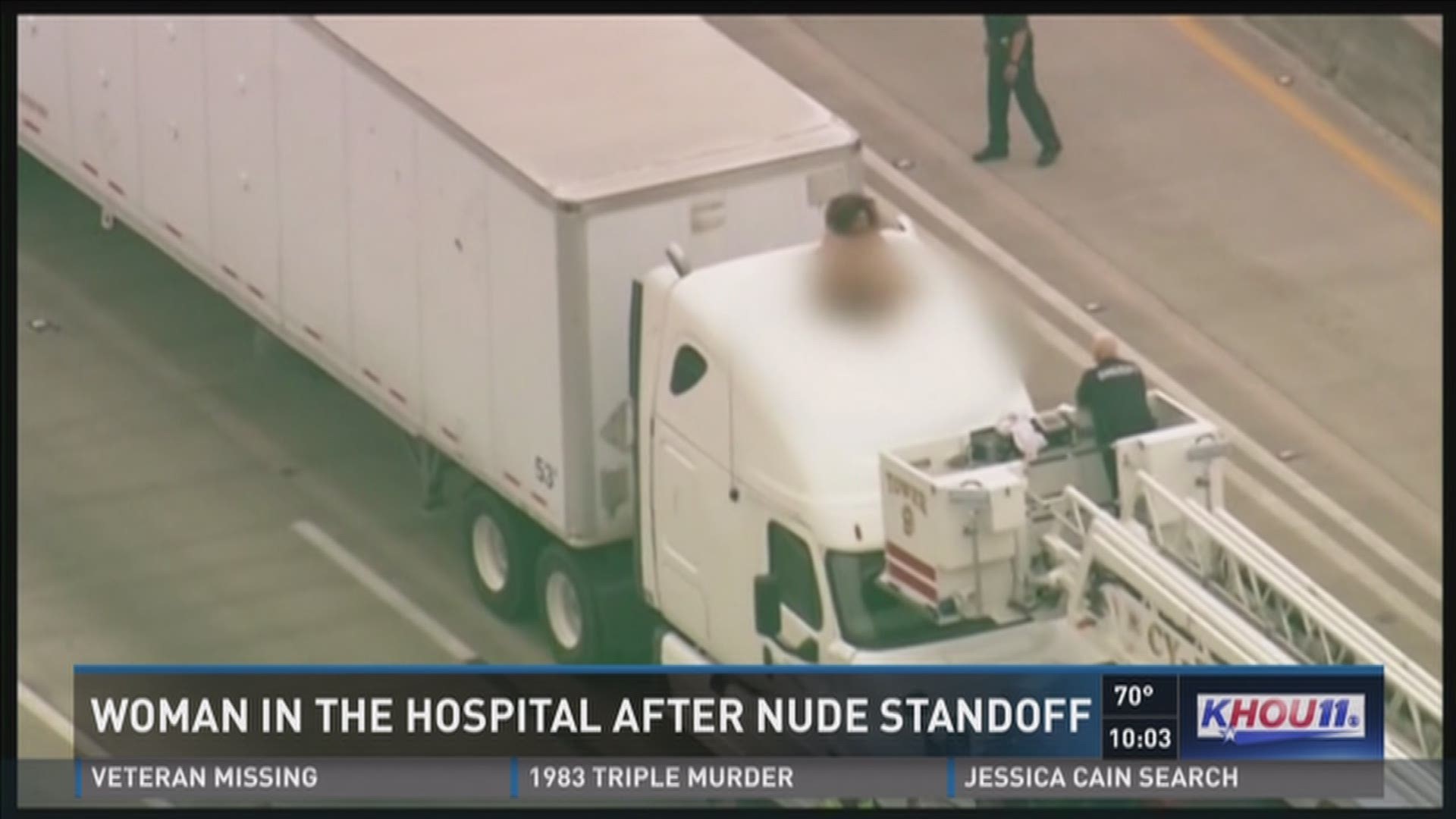 The woman stripped down naked and climbed on top of an 18-wheeler, halting rush hour traffic for two hours.