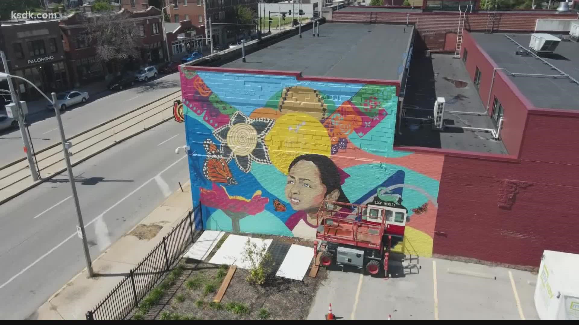 A group of artists is creating a mural on the Delmar Loop to represent their community.