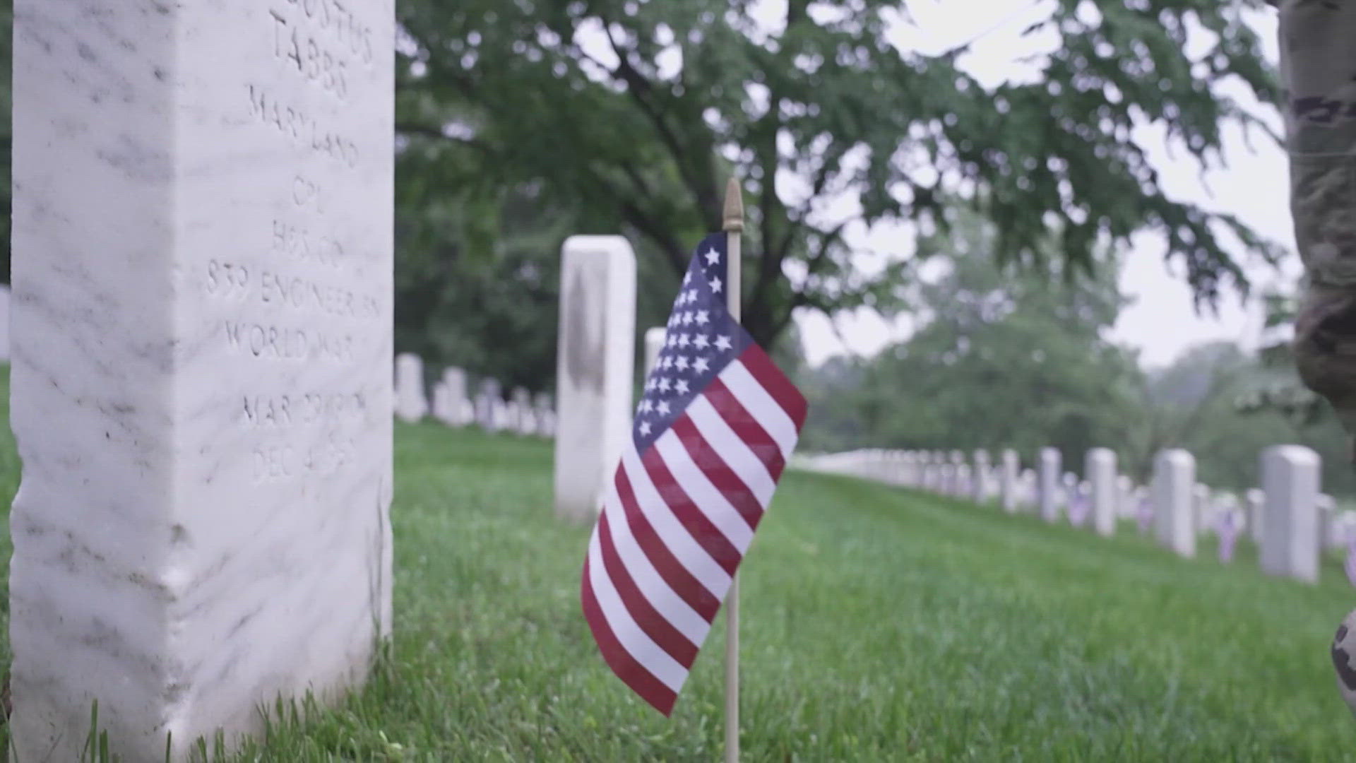 Flags are placed in front of headstones for fallen soldiers. 