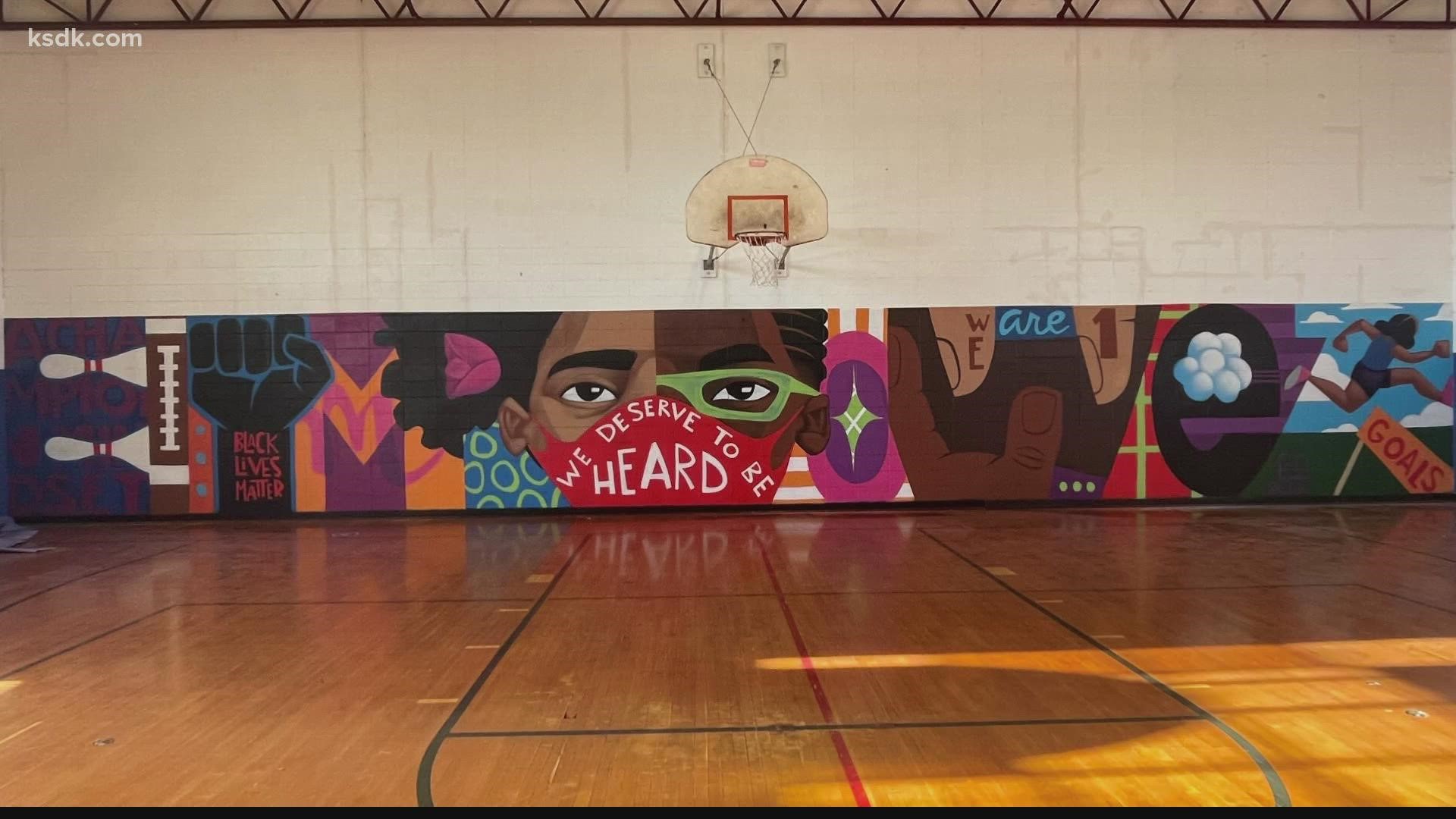St. Louis artist Cbabi Bayoc painted a mural at Cahokia High School. The words in the mural "Black Lives Matter" were painted over.