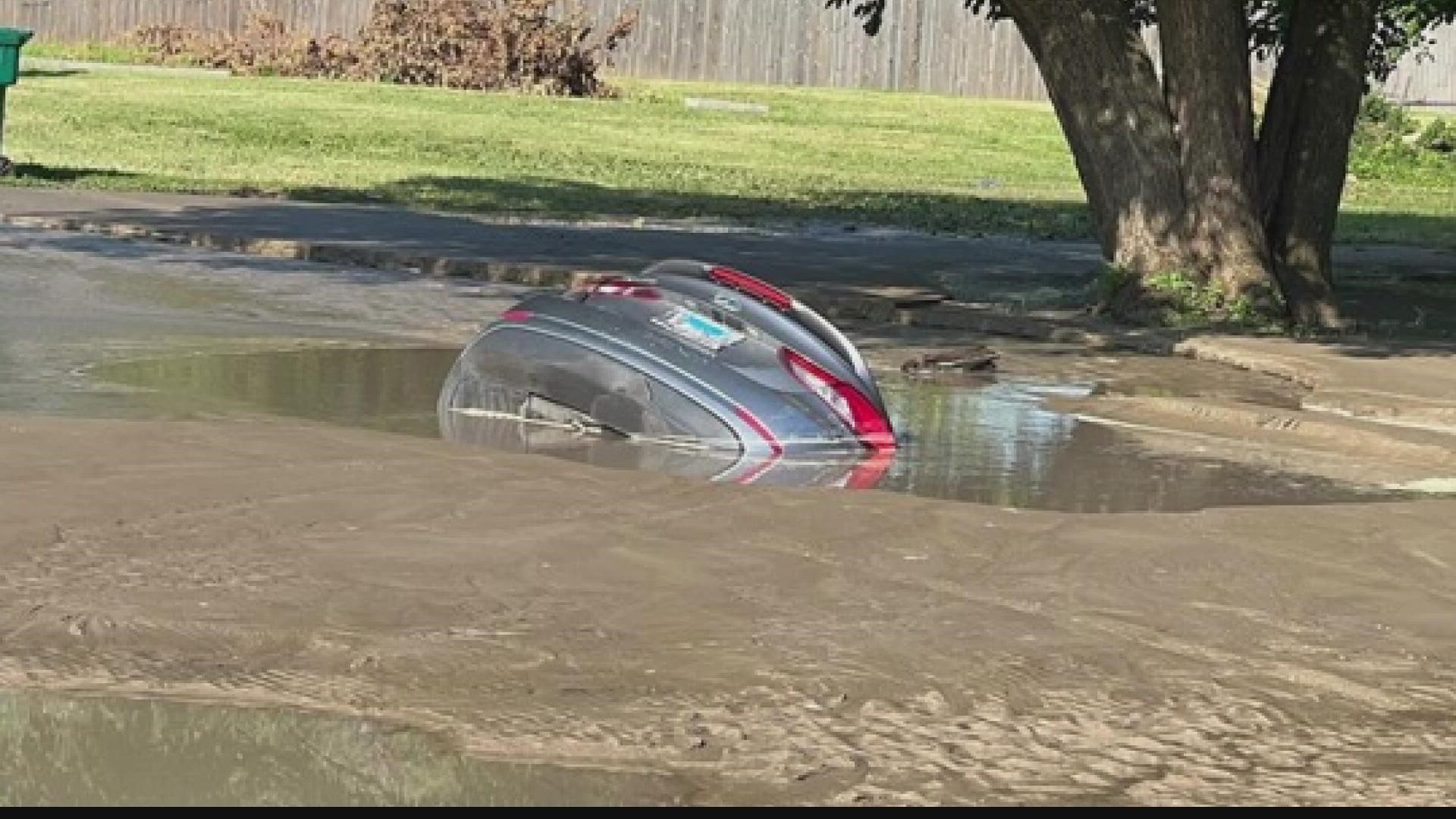A car completely was submerged in a massive sinkhole in East Saint Louis on July 4. On Saturday, residents returned to the site to call for action on infrastructure.