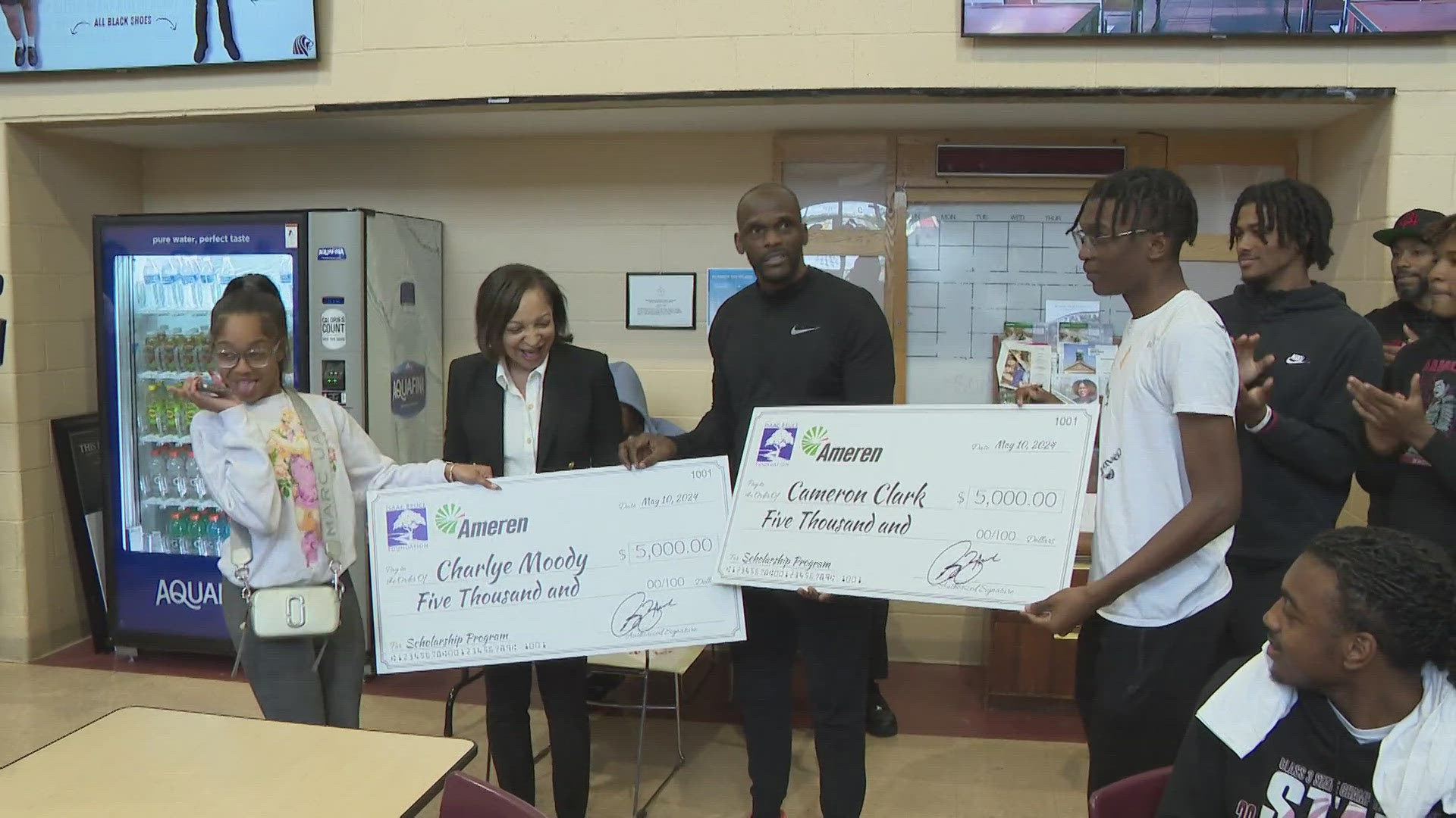 Isaac Bruce and Ameren presented scholarships to two students at Cardinal Ritter College Prep Friday. He hopes the program inspires recipients to pay it forward.