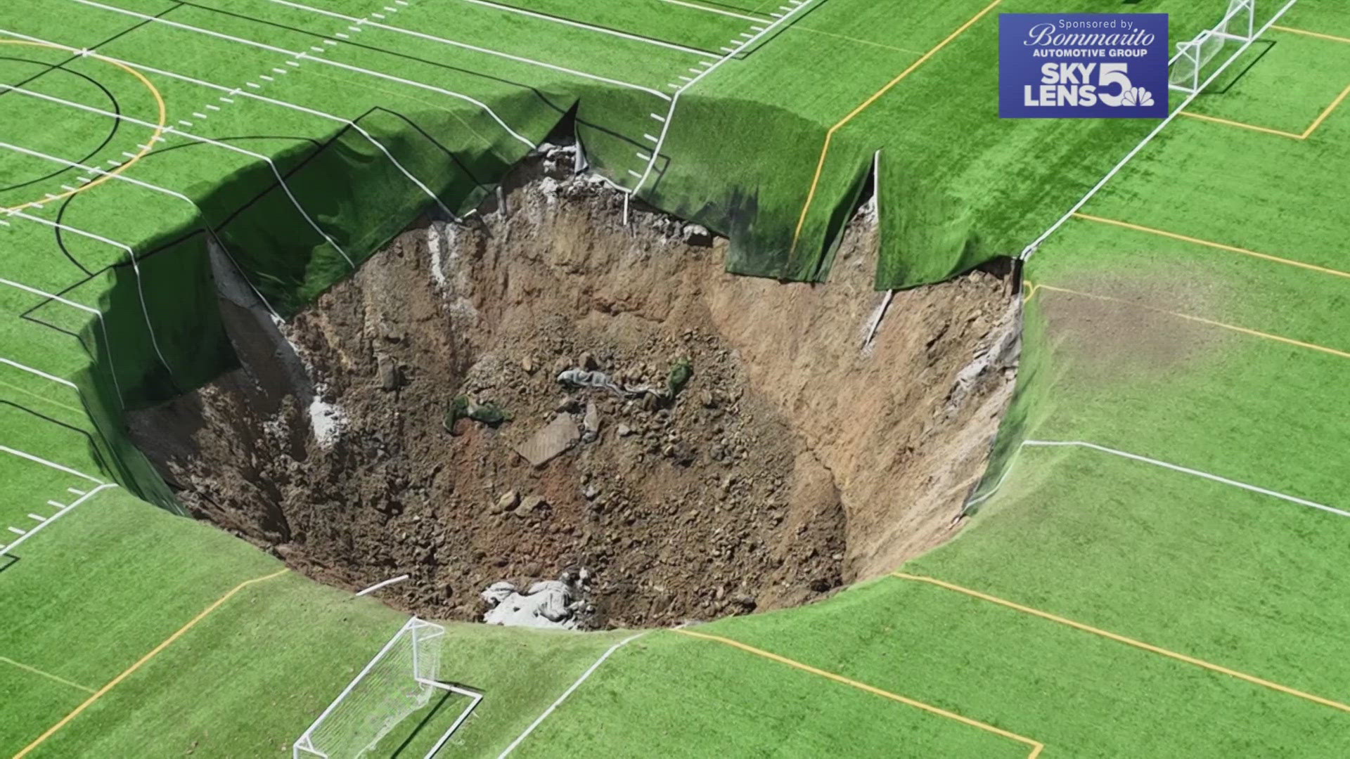 A sinkhole swallowed bleachers, a light pole and 100 feet of soccer fields at Gordon Moore Park in Alton, Illinois on Wednesday.