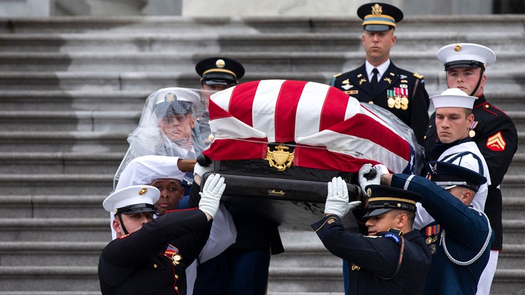 Pallbearers move the casket of former St. Louis Cardinals and