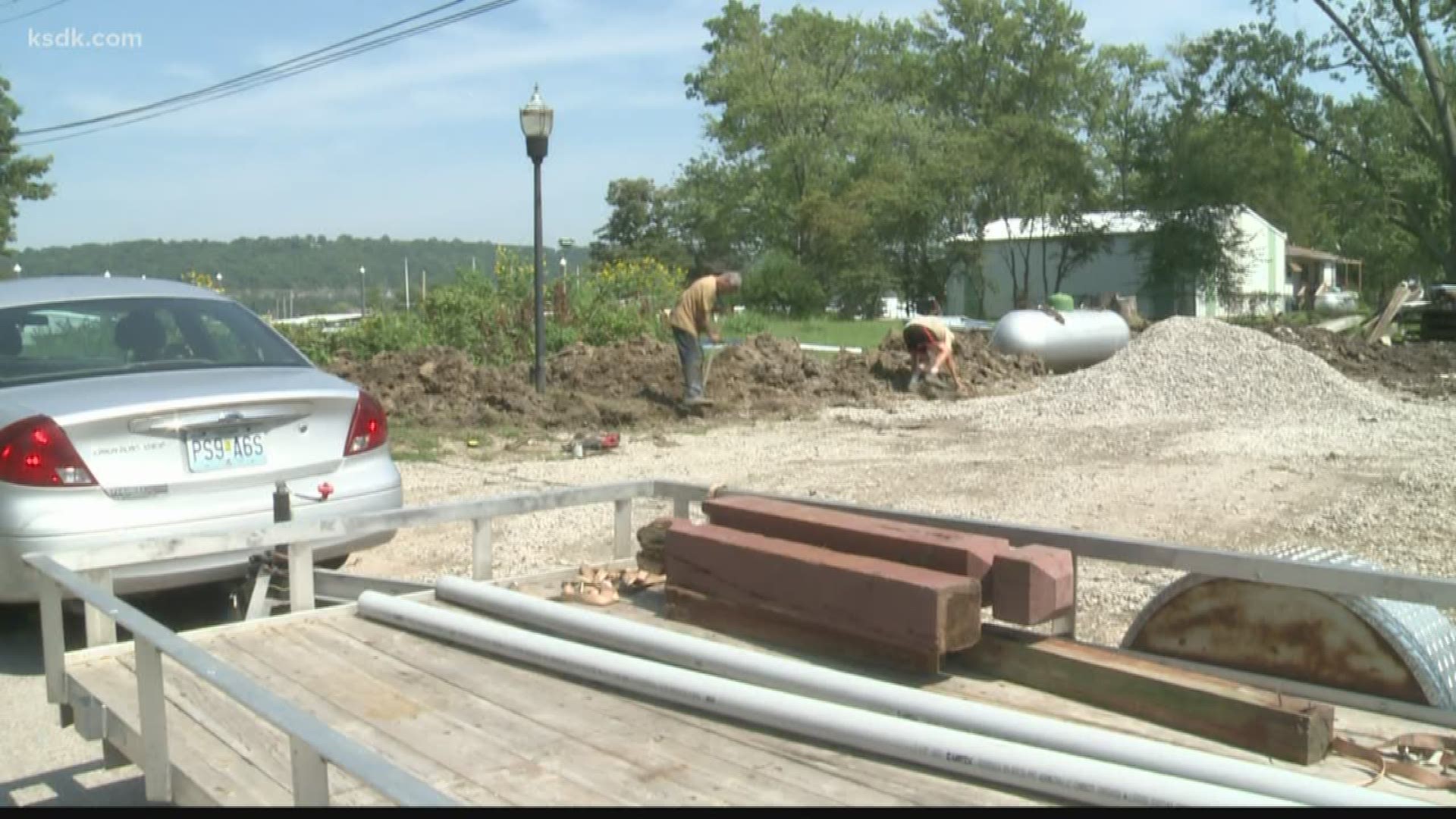 The record river levels brought on by spring and summer rain may be over, but people living in the flood zones are still underwater and homes are under construction.