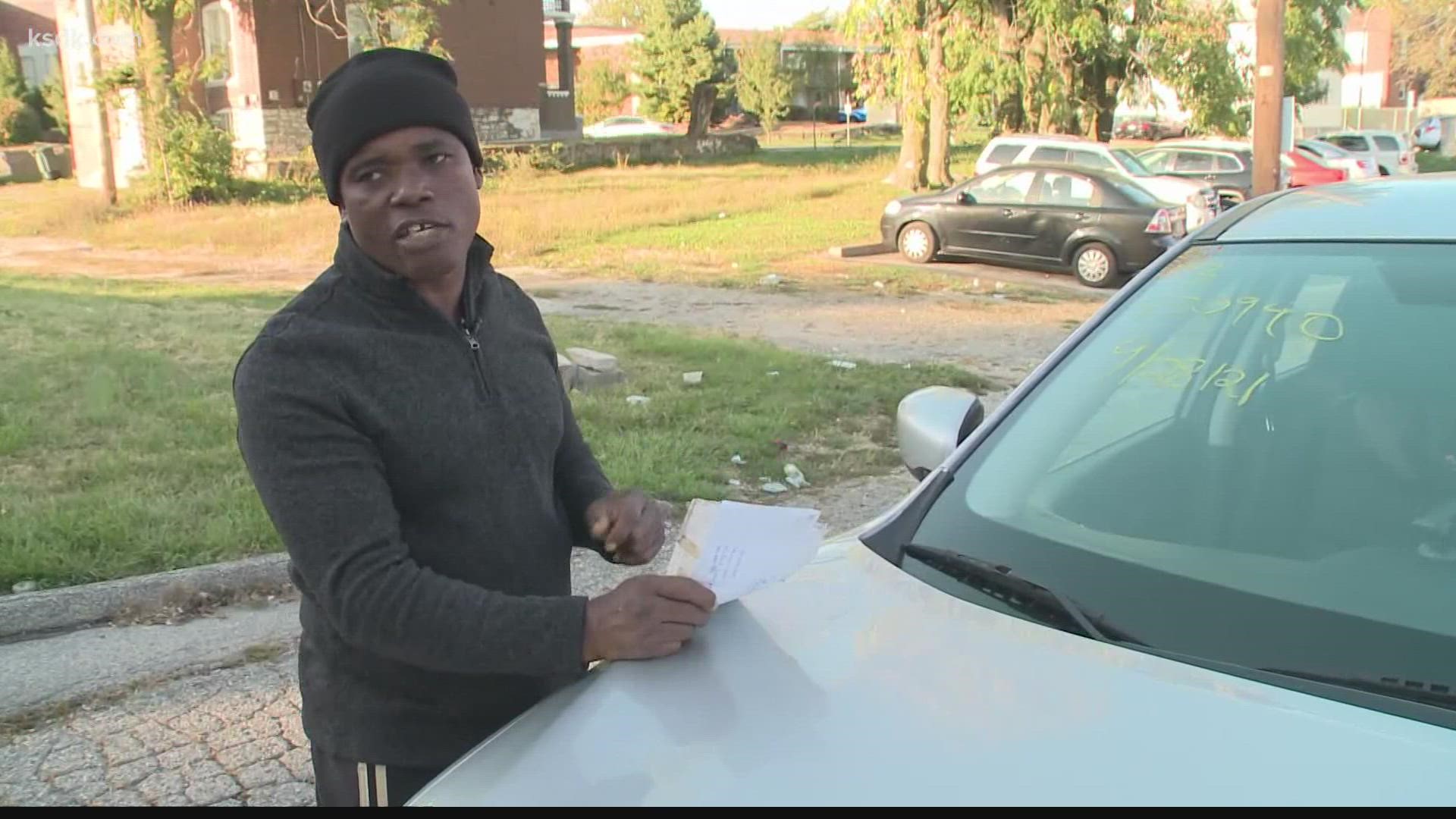 Konateh, 48, said he's been trying since Friday to give St. Louis police copies of two photos and paperwork he insists belong to a woman who carjacked him