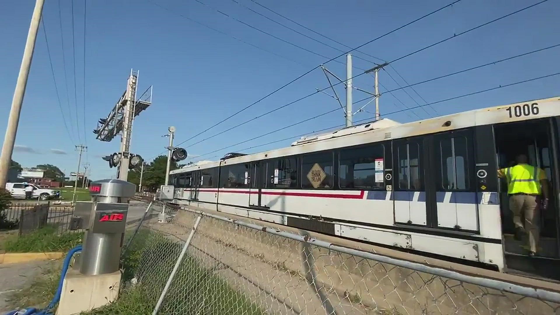 Officials say several people were shot in East St. Louis. A Metro train is seen stopped and there is a crashed car.