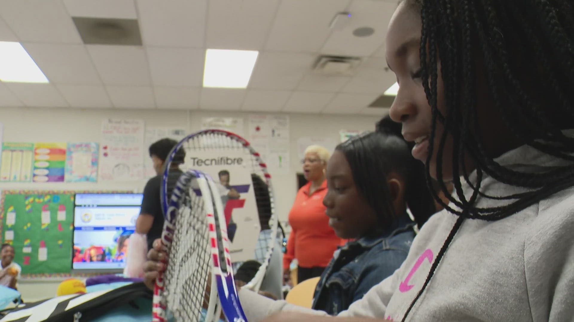 East St. Louis fourth graders received a gift bag containing a tennis racket and tennis ball. It's part of an effort to make the game more inclusive.