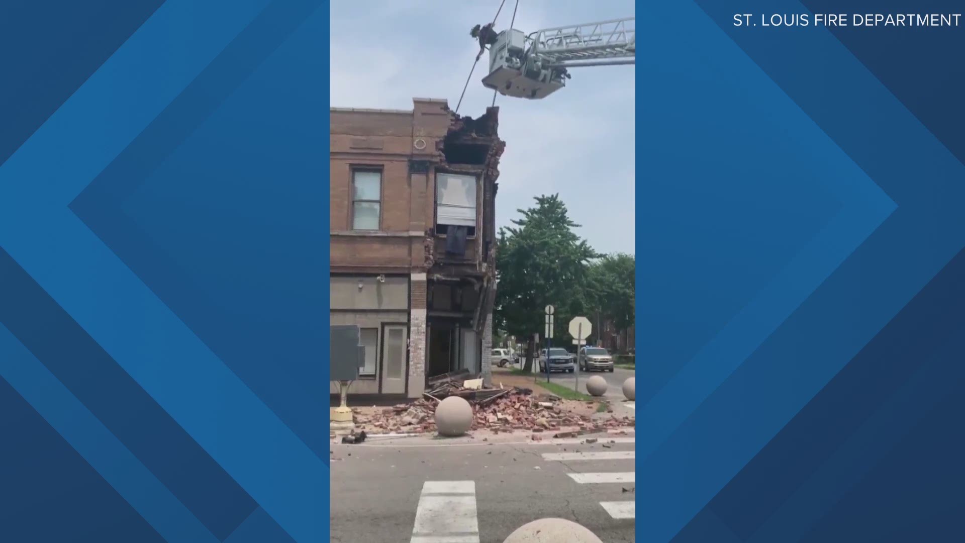 A car crashed into a building at Arsenal and Compton. The building started to collapse onto the car. After the car was removed, firefighters knocked bricks loose.