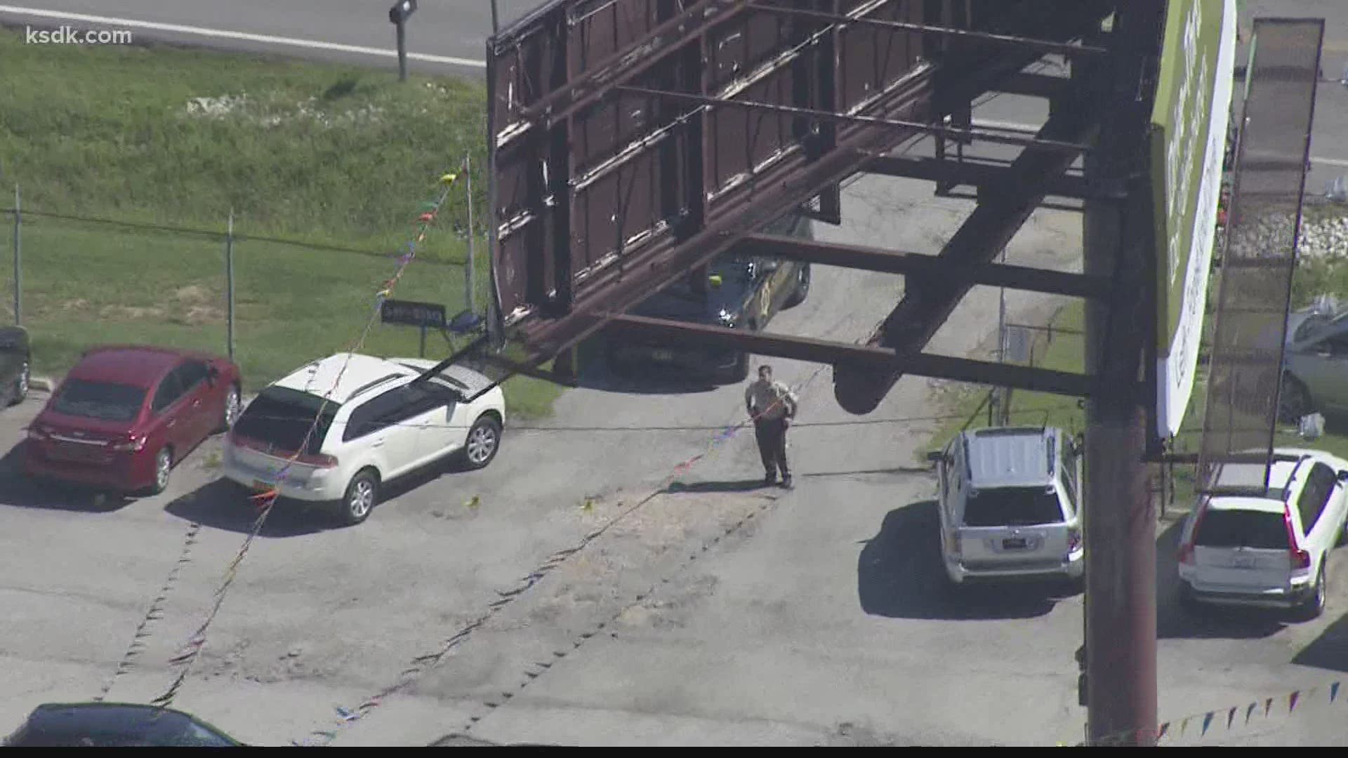 The suspects fired shots at a woman who noticed something was going on in a used car lot early Wednesday morning