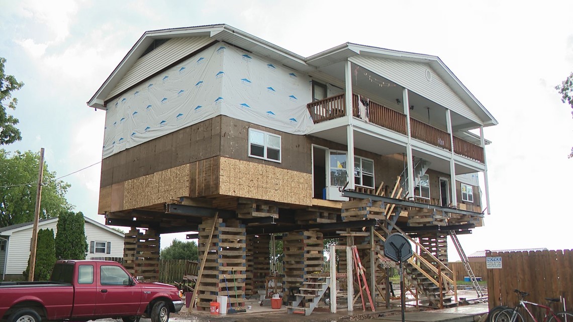 Homeowners in Portage Des Sioux lifting their properties after flooding