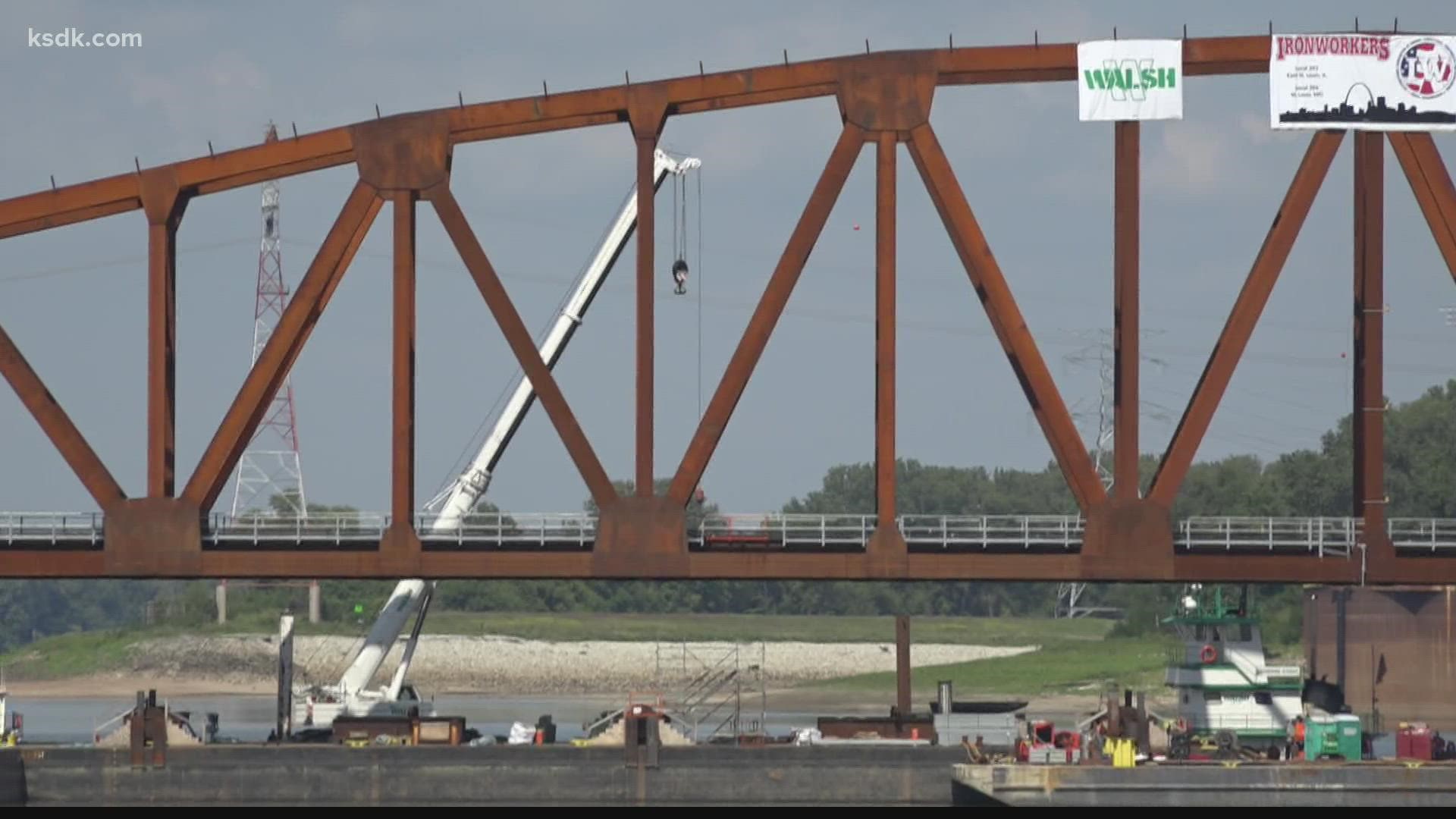 The first new section of a renovated railroad bridge was installed. The Merchants Bridge was built in 1890.