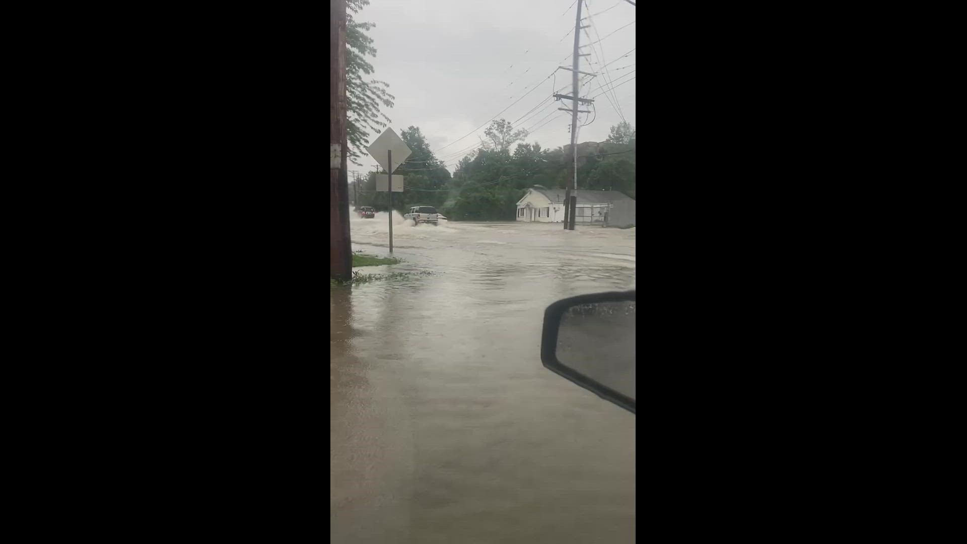 Cars drive through flooded roads in the Oakland area in St. Louis County Thursday morning. This is near Big Bend and Sanders. Credit: Hannah Lagermann