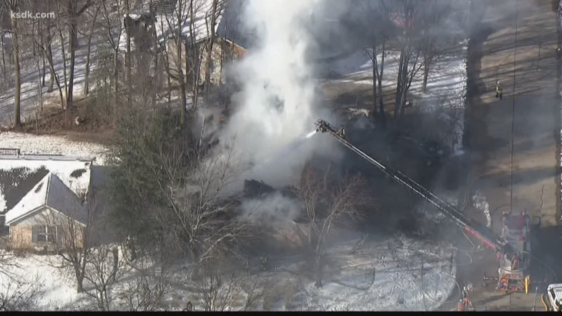 Firefighters say the fire started behind the house, then spread to it.