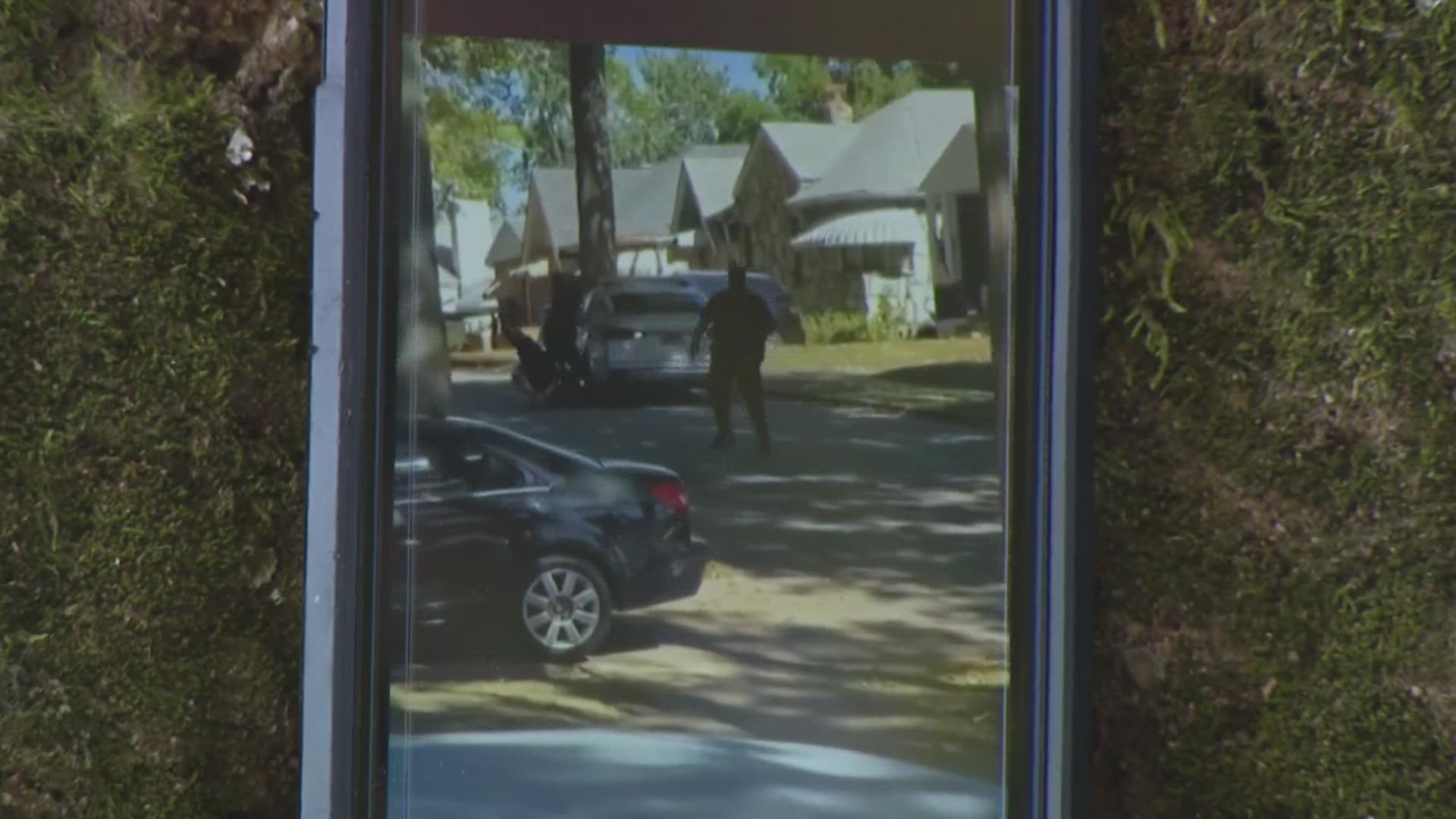 Scharell Houston watched from her front porch as a woman slipped past police and into their patrol car Sunday. But she says this is the best-case scenario.