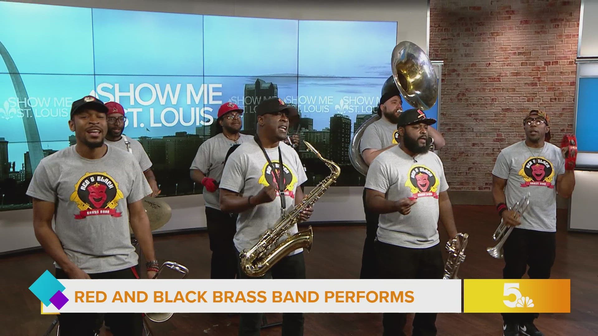 The Red & Black Brass Band performs an original song