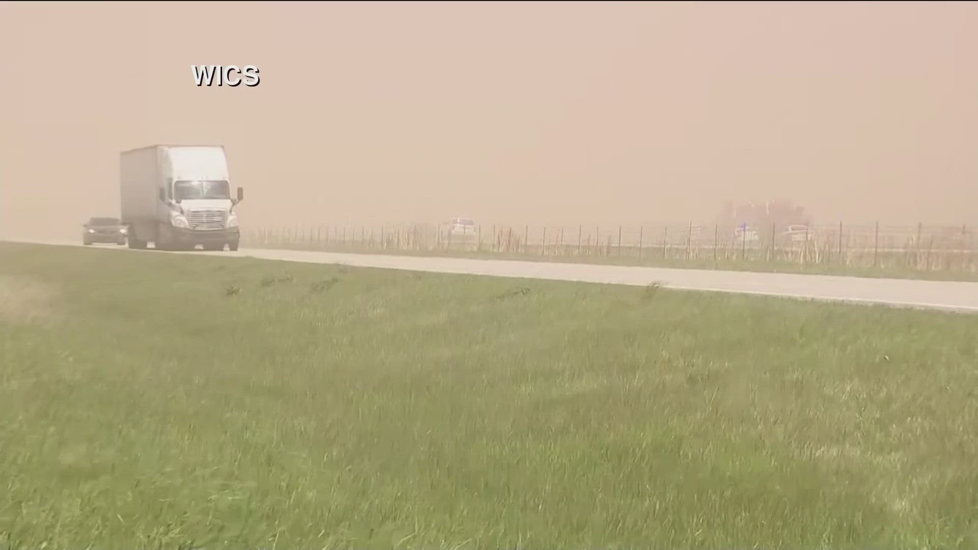 Vehicles veer through blowing dust on the outer road of Interstate 55 near Farmersville, Illinois. The highway is closed between mile marker 63 to 80.