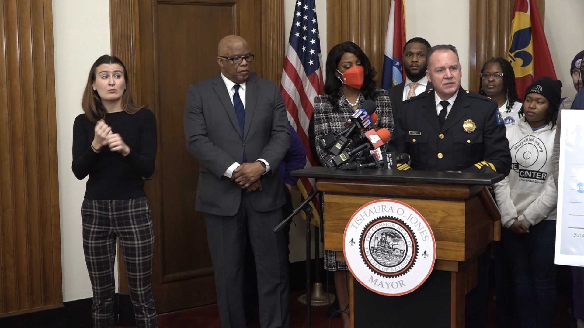 Standing alongside Chief Tracy and poster boards showing a homicide graph, Jones highlighted the city's reduction in annual homicides.