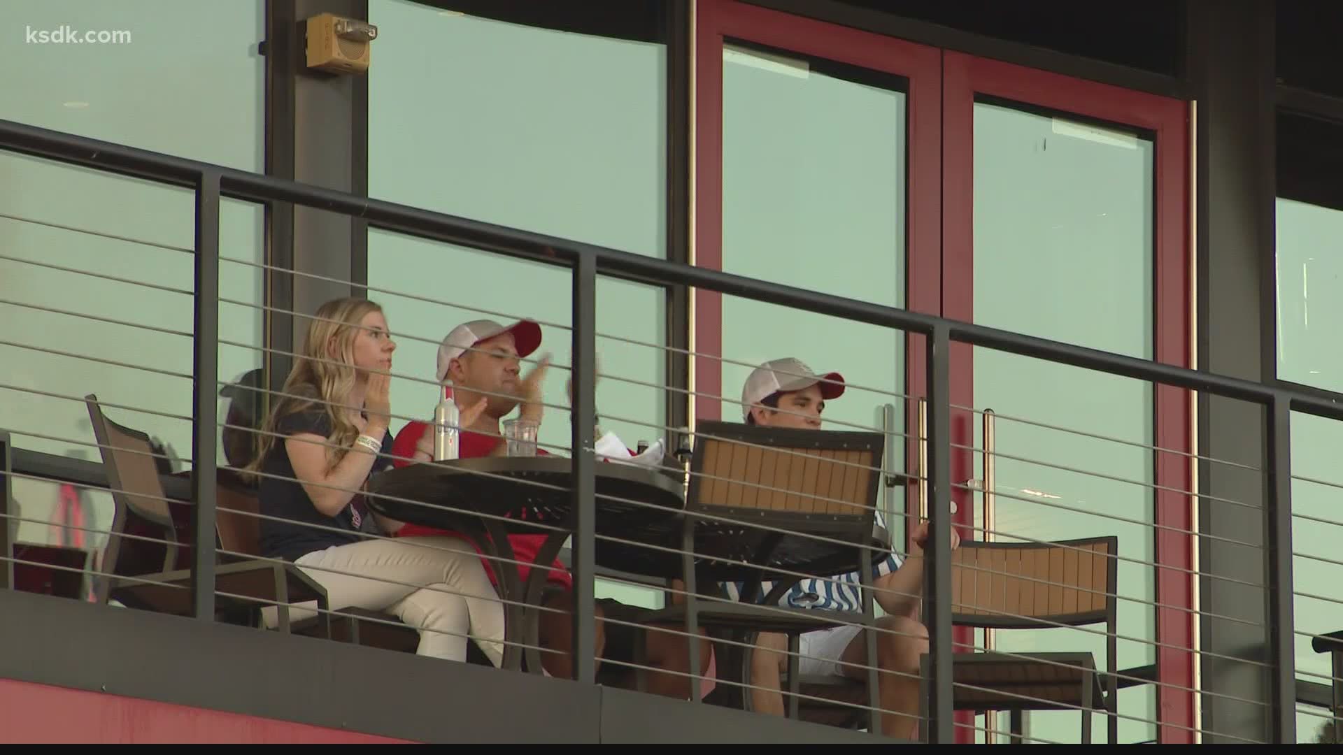 Cardinals fans gathered outside the stadium to watch their Cardinals from a safe distance