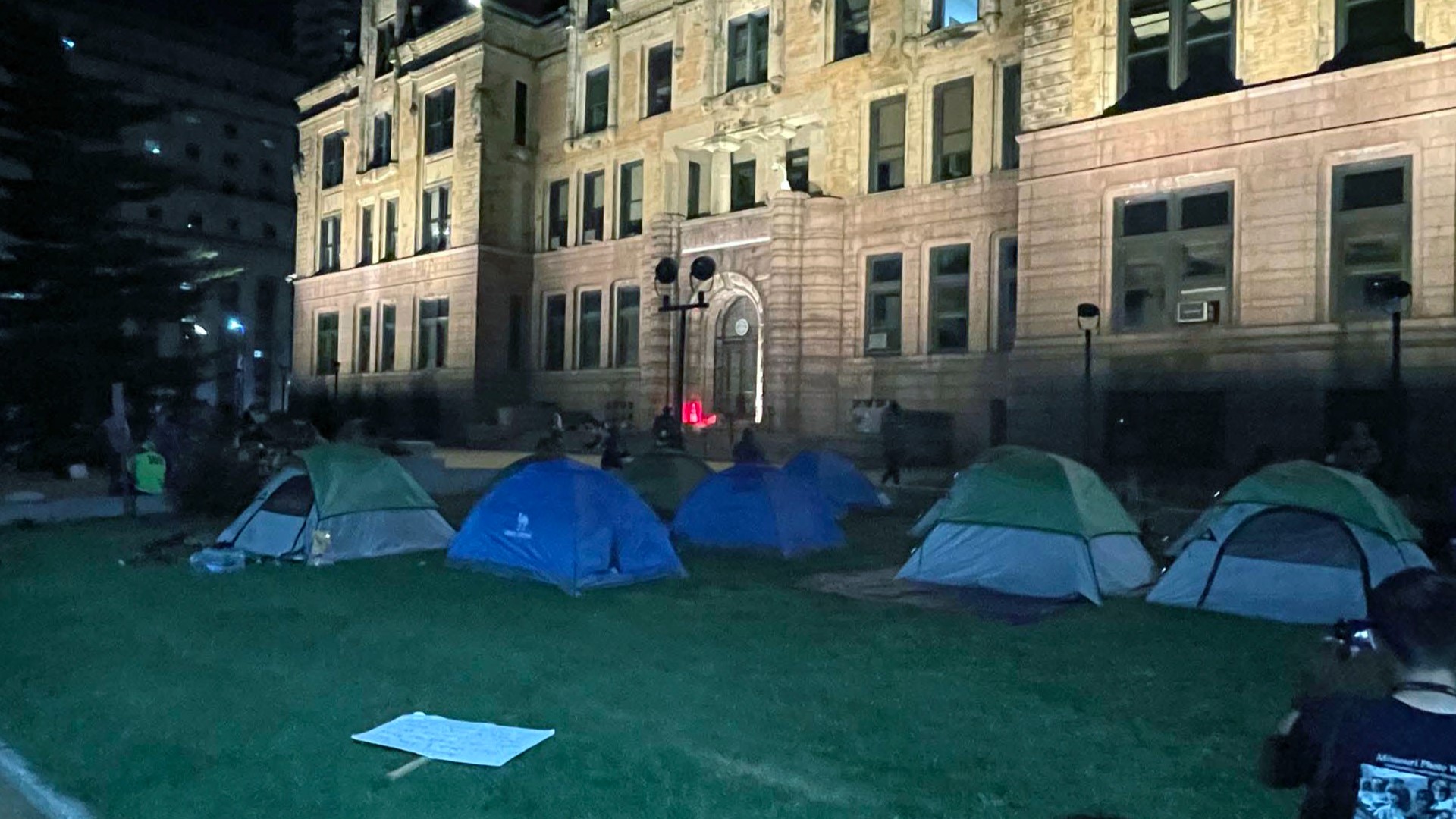 Dozens of people living in a makeshift encampment on the lawn of St. Louis' City Hall were forced to move Monday night.