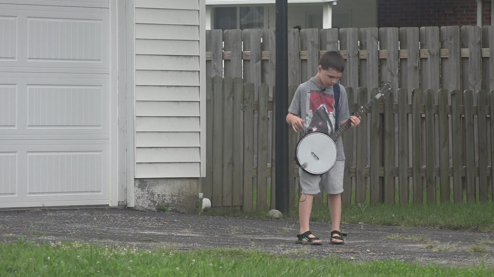 8-year-old Sam Gillespie raised more than $300 for Shriner's Hospital by playing his banjo in the backyard.