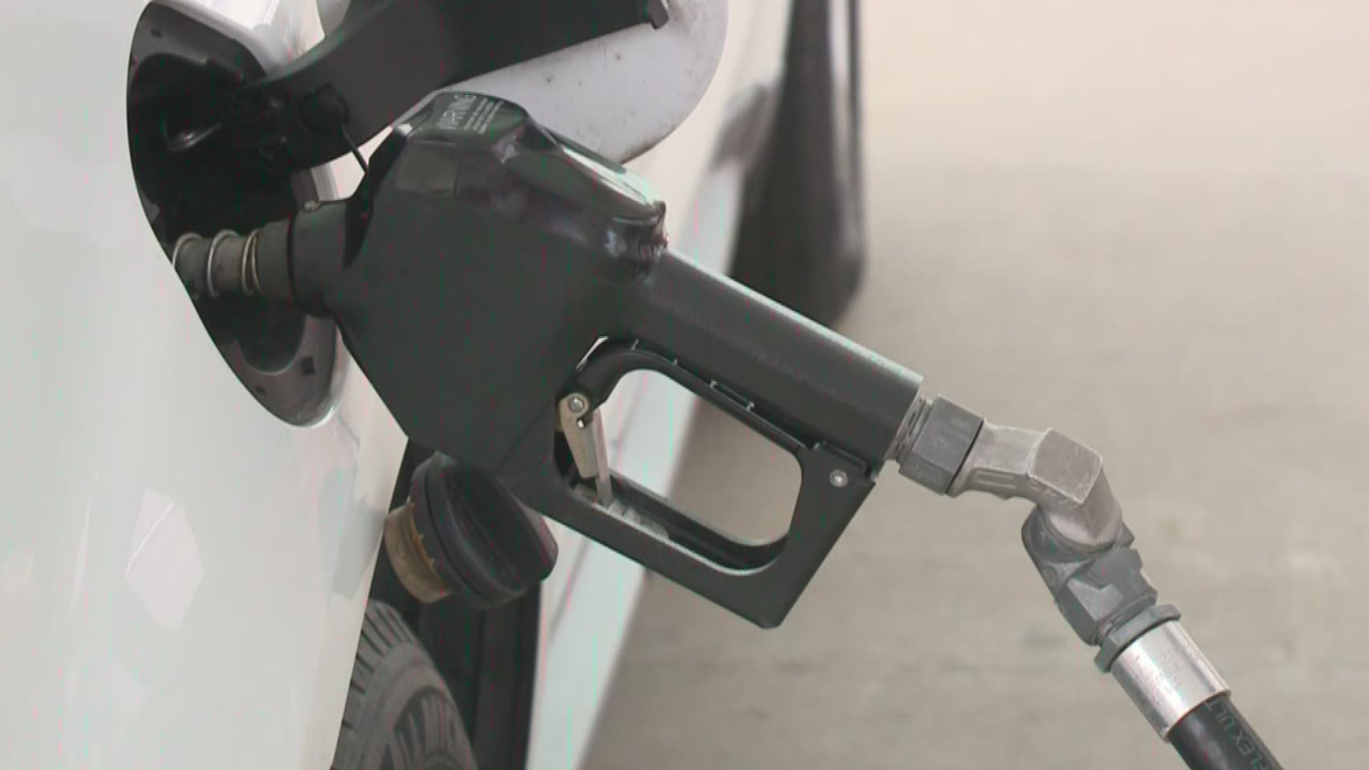 Police are looking for two people who carjacked a woman at gunpoint while she was pumping gas.