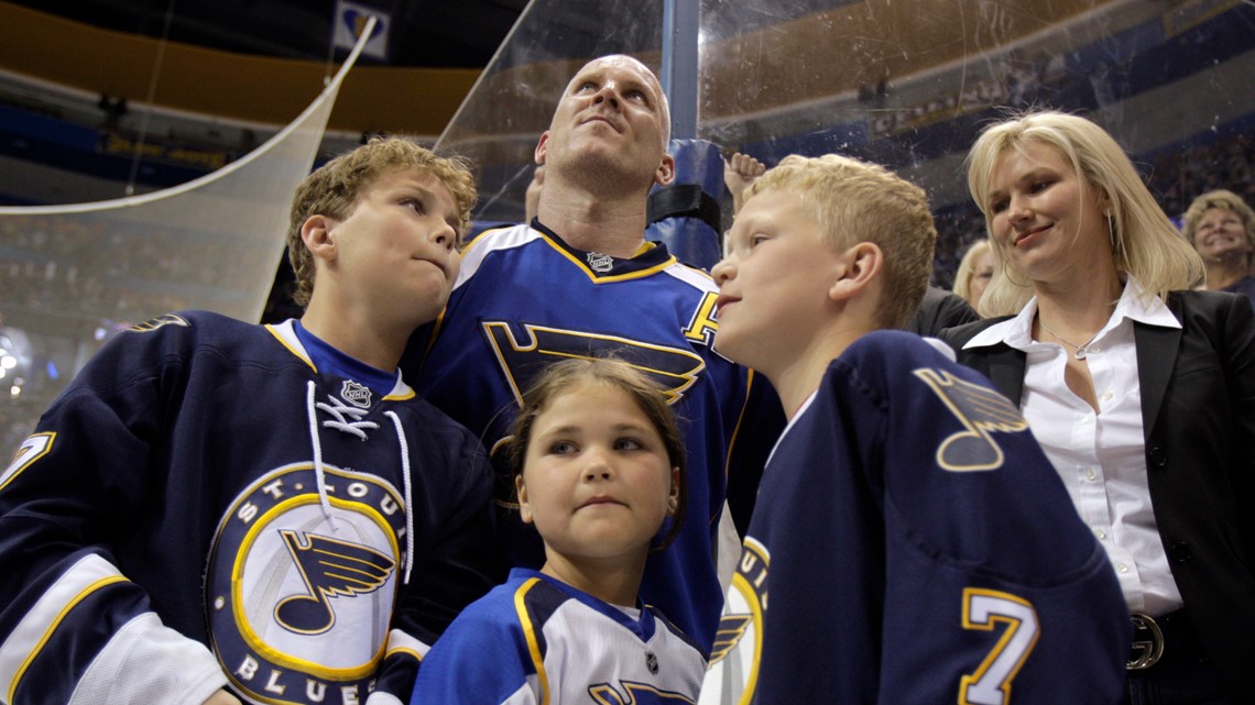 The family of St. Louis Blues Keith Tkachuk (L to R) Braeden, 10, Matthew,  12, Taryn, 7, and wife Chantal, listen during a press conference honoring  Tkachuk for his years of service