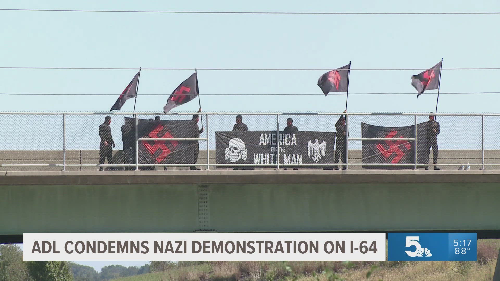 A group dressed in all black appeared on an Interstate 64 overpass in the St. Louis area, holding flags bearing Swastikas in red and black. Many condemned the hate.