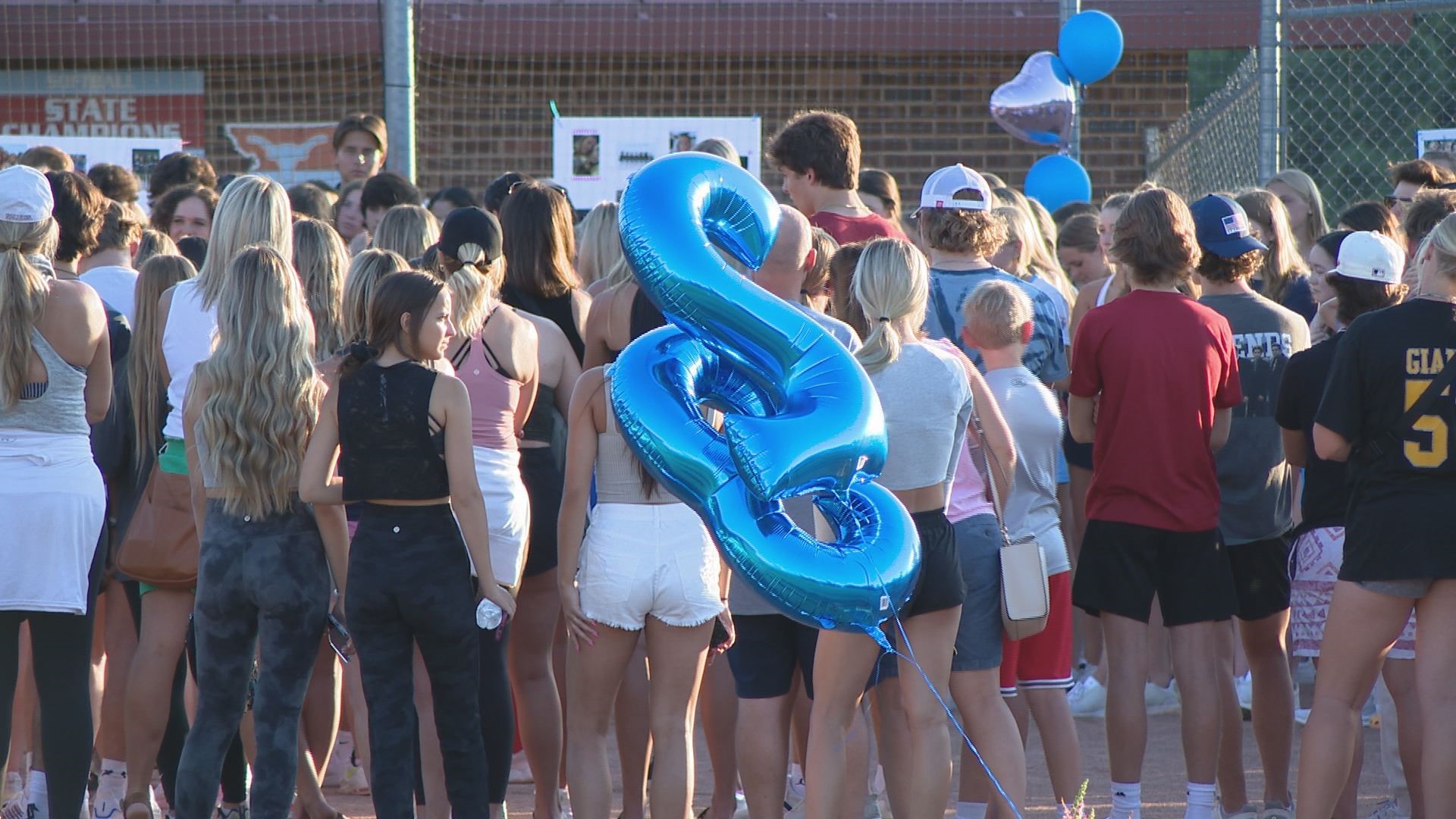 A few hundred people remembered 15-year-old Kendall Johnson on the school's softball field where she once played.