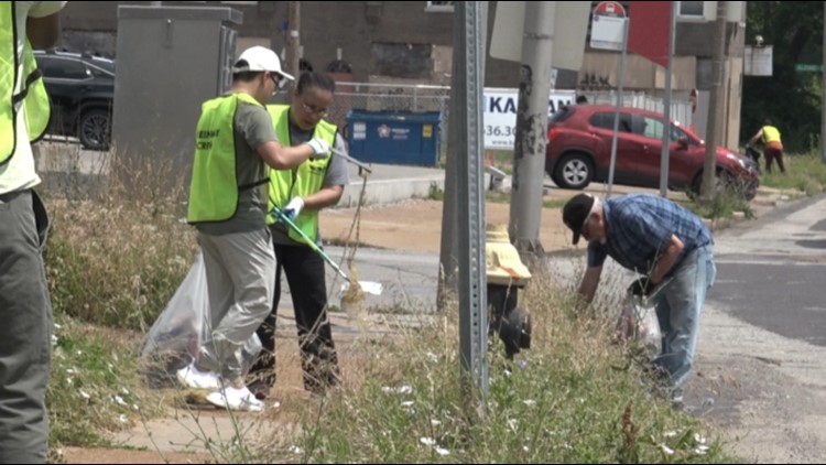 Volunteers pickup trash along Grand Boulevard in north St. Louis