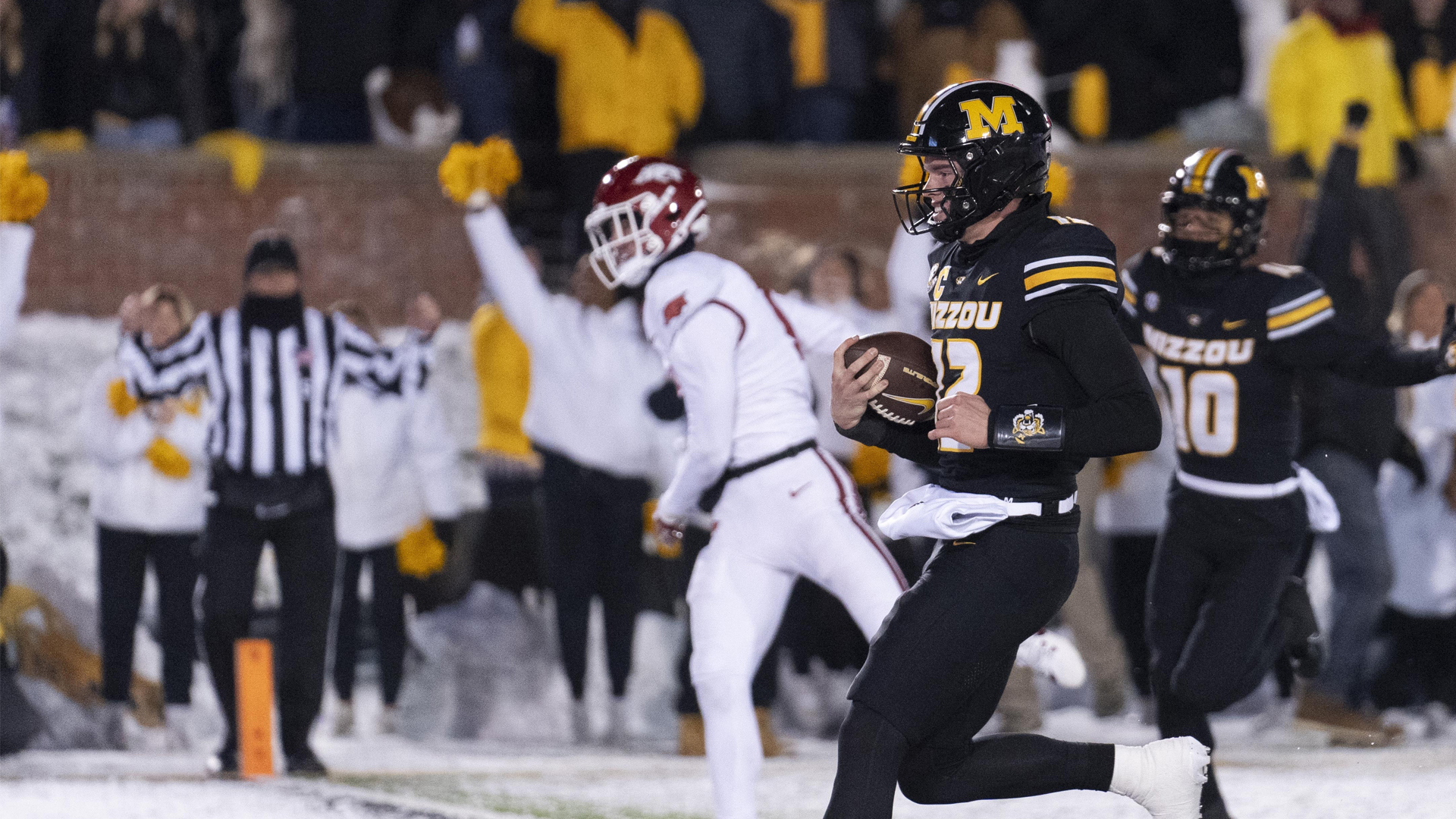 Brady Cook rushed for a 30-yard touchdown with 1:53 remaining, and No. 24 Missouri beat Arkansas 28-21 on Saturday at a snow-covered Faurot Field.