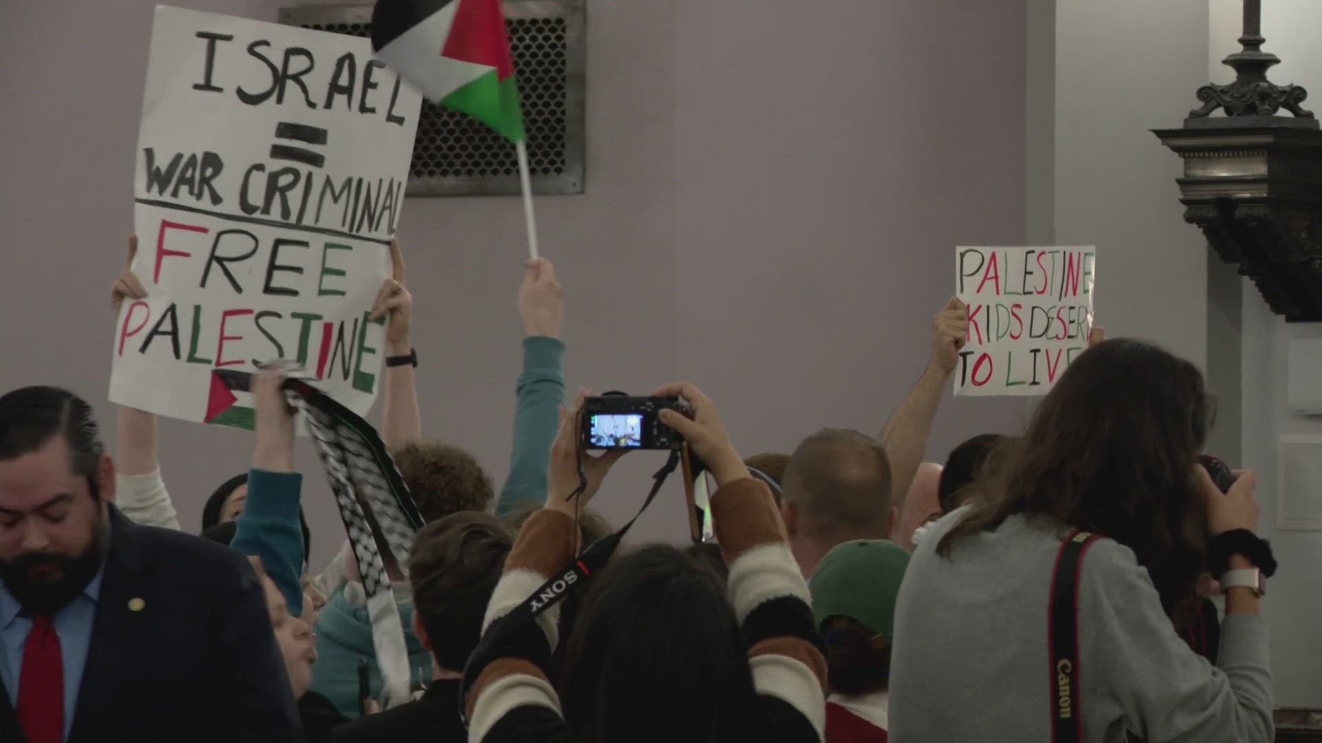 Police ushered dozens of Palestinian-American protestors out of the St. Louis Board of Aldermen chambers today.