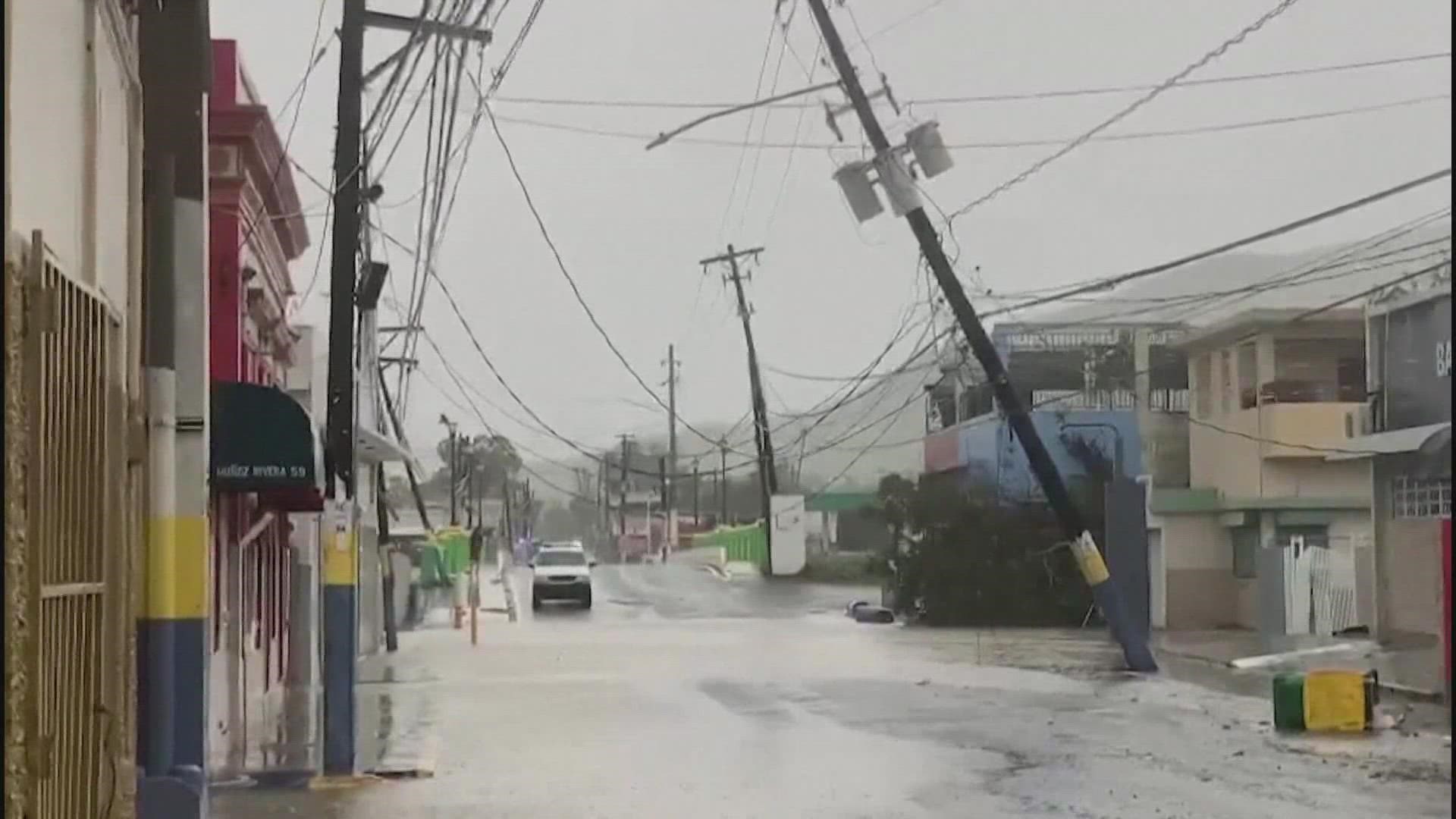 The hurricane-hit island is battling torrential rain, mudslides and wild winds.