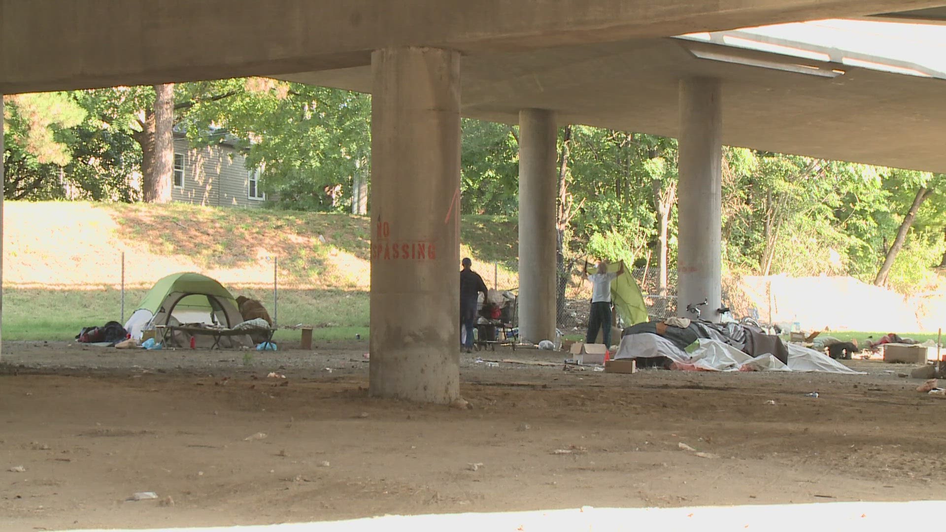 Workers and law enforcement were seen at the overpass Wednesday.