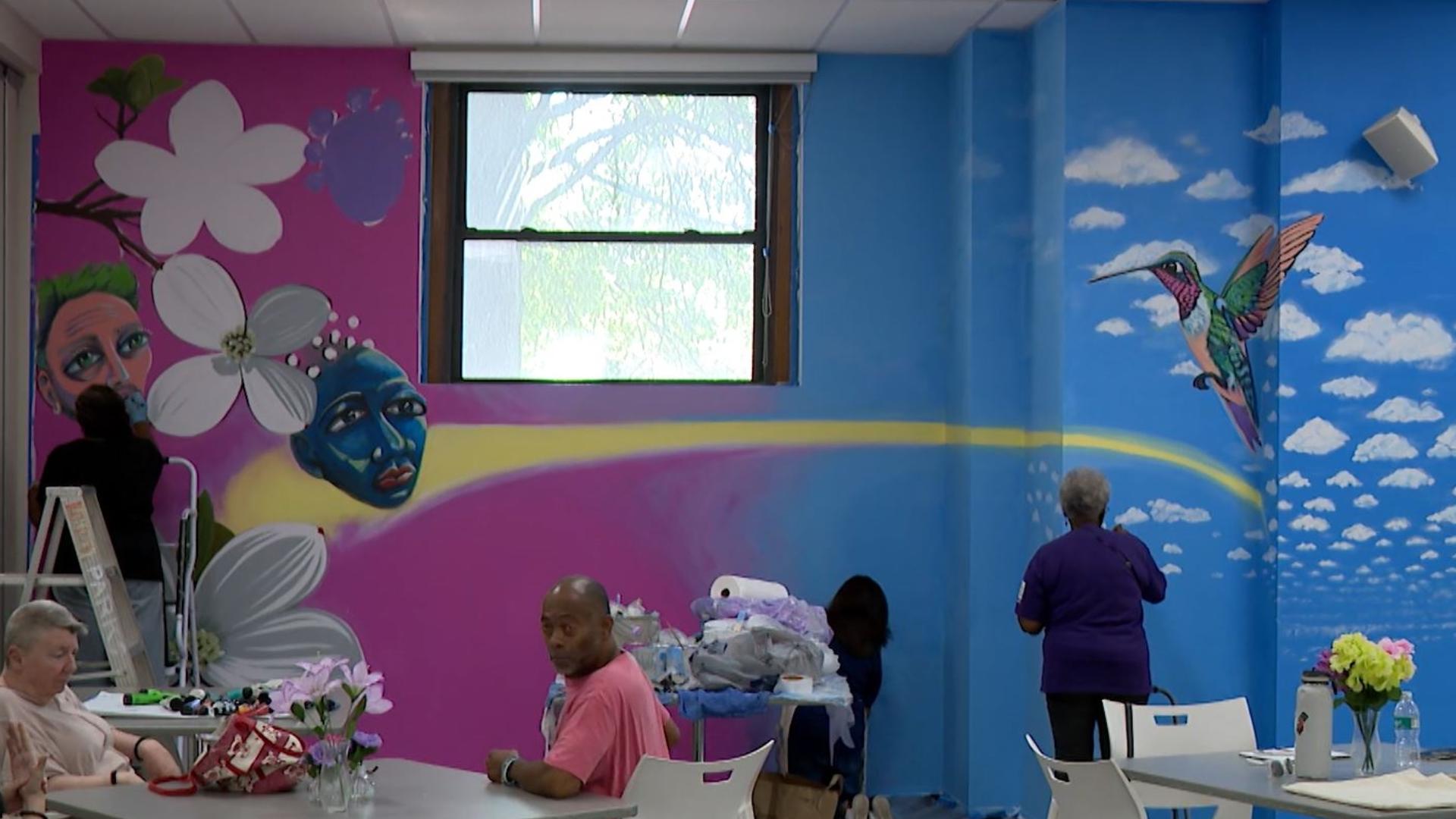 Two artists in the Old North Neighborhood have worked with a transitional housing group to paint a dining room wall.