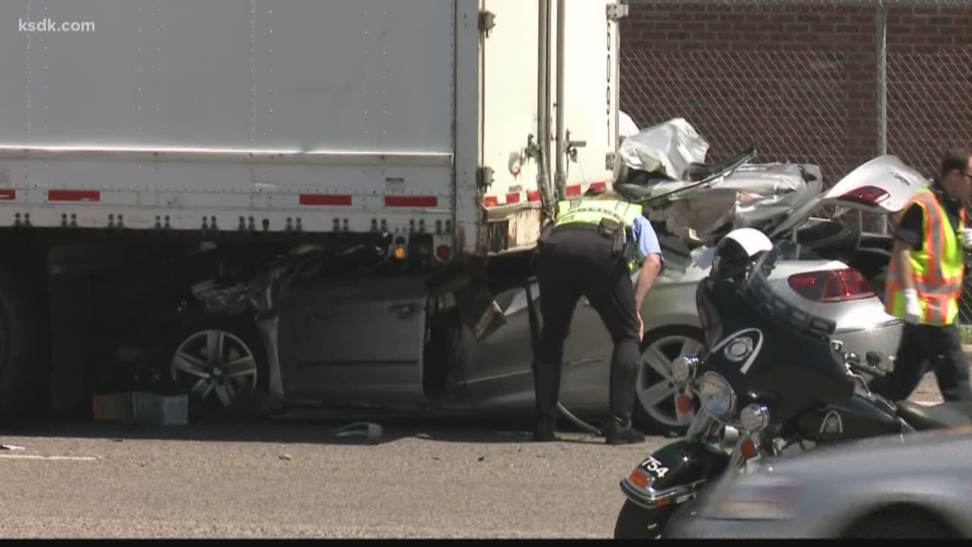 A passenger car crashed into the back of a tractor trailer. Two people inside the car were killed, according to St. Louis police.