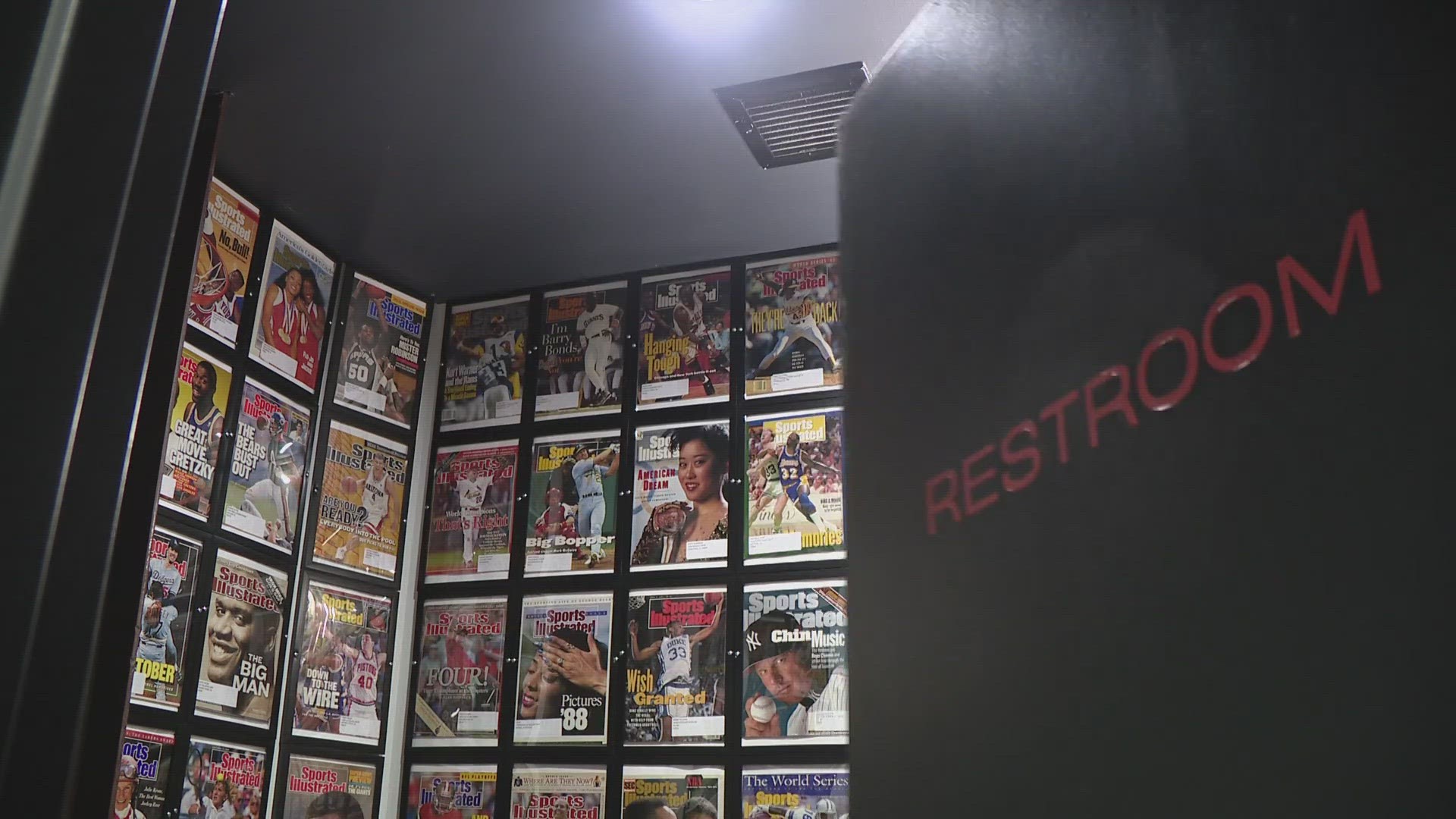 The walls of the men's room at Burger Champ are lined with legendary covers of Sports Illustrated.