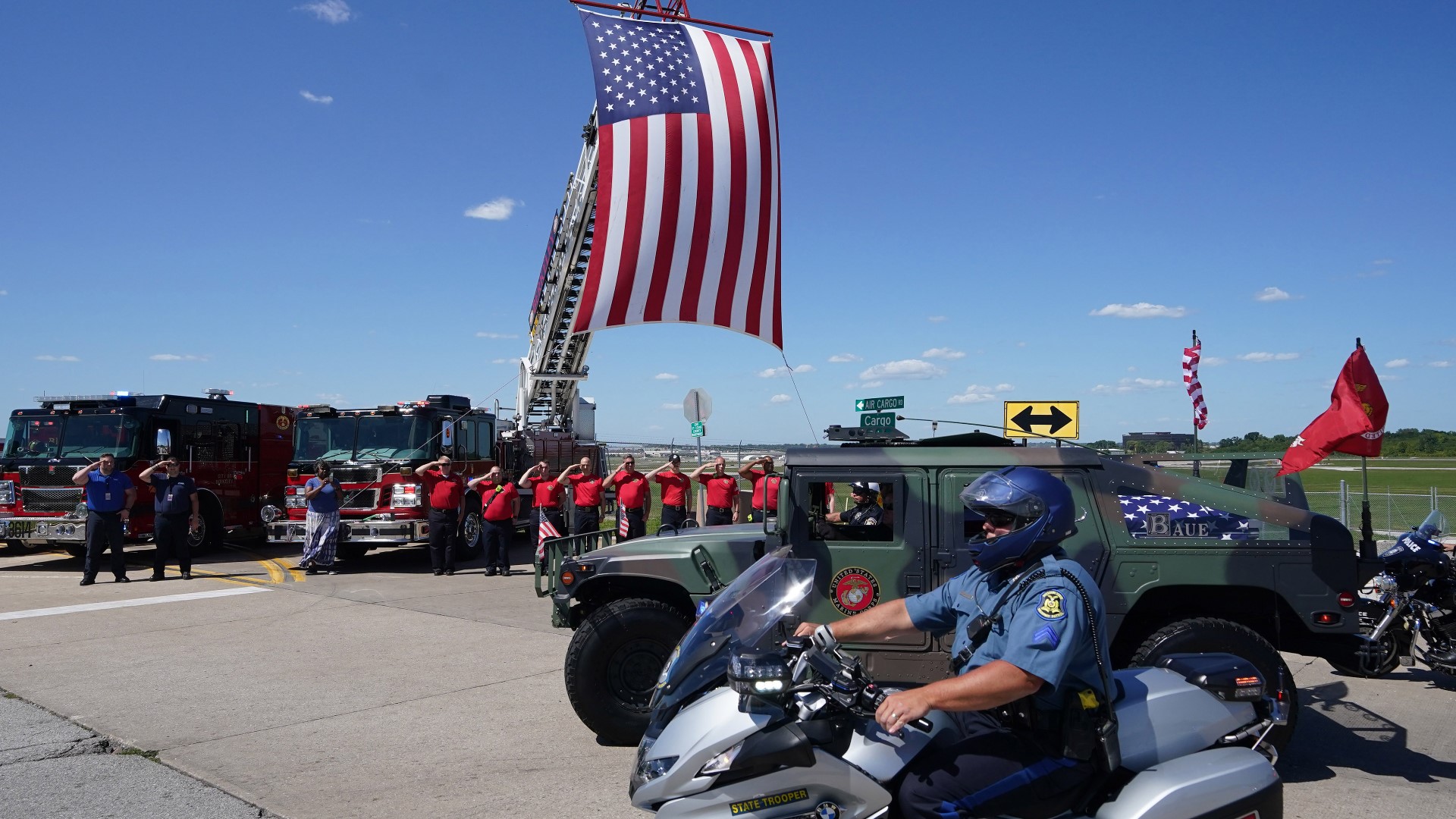 A stream of vehicles and motorcycles escorted Lance Cpl. Schmitz's remains, while flag-waving residents lined the route to honor the hero