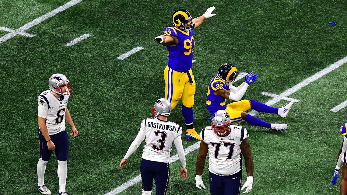 New England Patriots' Tom Brady (12) passes under pressure form Los Angeles  Rams' Aaron Donald (99) during the first half of the NFL Super Bowl 53  football game Sunday, Feb. 3, 2019